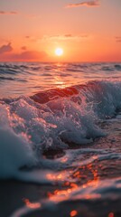 Fototapeta premium Ocean wave splashing during a vibrant sunset