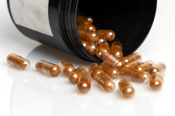 Cordyceps mushroom powder in capsules isolated on white background. Long and healthy life, longevity theme