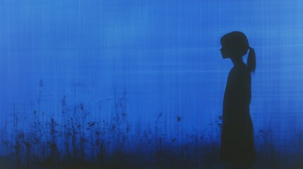 Fototapeta premium Silhouette of a young girl in a serene blue landscape with subtle nature elements