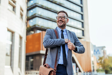 Confident Businessman Smiling Outdoors in Urban Environment