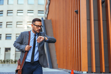 Businessman Checking Watch While Walking in Urban Area