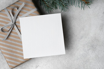 White Christmas or New Year holidays card mockup with copy space, blank square card with gift box