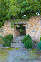Naklejka premium A stone wall with a door and a path leading to it