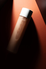 mockup of cosmetic product tonic on delicate orange background. cosmetics design.