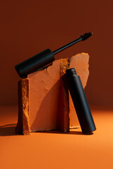 Close-up mockup of empty smooth mascara with delicate brush on soft, blurry, expensive background. Elegant brick effect adds a touch of luxury, perfect for beauty and makeup themes.