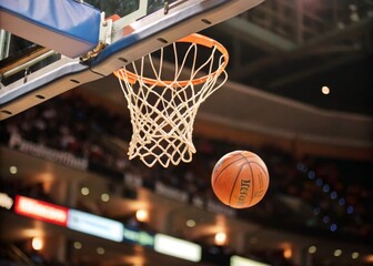 Fototapeta premium Tilt-Shift Photography of a Basketball Flying into the Basket, Close-Up Capture of Victory Moment with Net, Sports Action, Dramatic Angle, Basketball Court, Excitement, Winning Shot