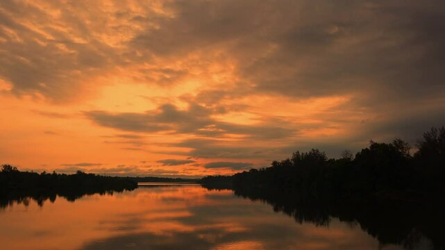 Riverside sunrise timel apse in 4K resolution, People going for fishing in early morning