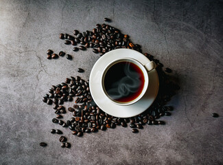 Coffee cup and coffee beans on gray background, Black coffee cup aromatic, top view