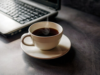 Relax during business work concept, americano coffee cup and black coffee cup aromatic and laptop computer in morning