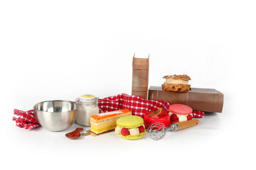 Assortment of cakes with kitchen utensils on a white background