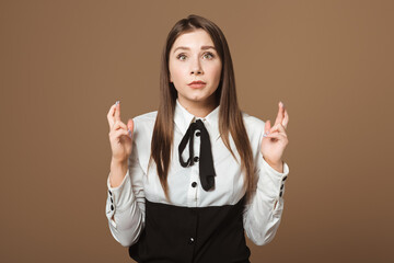 Portrait of a Attractive Brunette Crossing Fingers. Young Woman Eagerly Awaiting the Fulfillment of...
