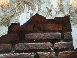 Old cracked wall background showing bricks underneath