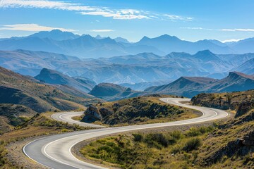 Naklejka premium Winding Road Winds Through Mountain Valley on Sunny Day