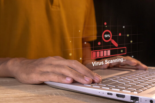 Man working on laptop with virtual screen of virus scanning process. Anti virus and bug protection technology concept.