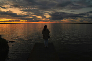 Girl on a bridge at sunset