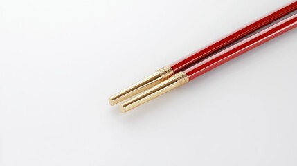 Pair of chopsticks with red and gold details, on white background.
