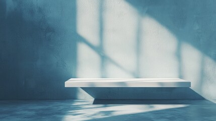 Empty table on smooth blue wall background. Composition with abstract light reflections and shadows. Mock up for winter presentation, branding products, cosmetics and food.