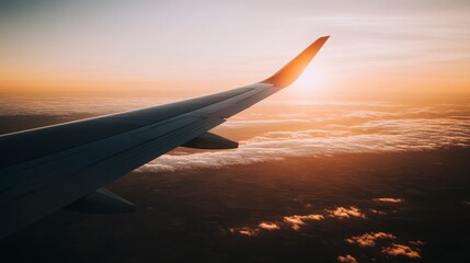 Fototapeta premium Breathtaking View of Airplane Wing Against Vibrant Sunset Skies with Soft Clouds and Golden Light Illuminating the Horizon During a Serene Flight Experience