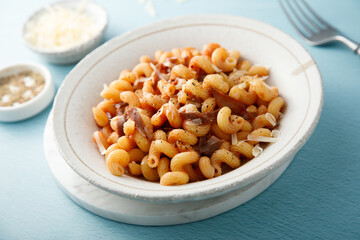 Pasta with tomato sauce and smoked ham