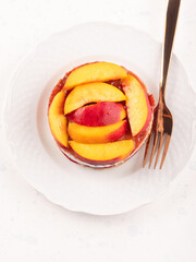 Overnight chia pudding dessert with greek yogurt, peaches and jam