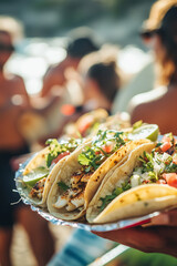 Crispy fish tacos with lime and cilantro served at a beach gathering