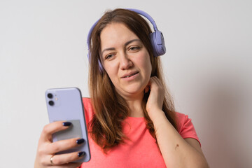 Modern woman smiling with braces on her teeth and listening to music