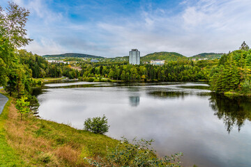 Fototapeta premium A view along the length of the Glynmill pond on the Corner Brook Stream Trail at Corner Brook in Newfoundland, Canada in the fall