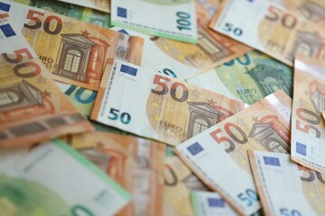 Pile of euro paper banknotes as finance background. Financial, saving or investment