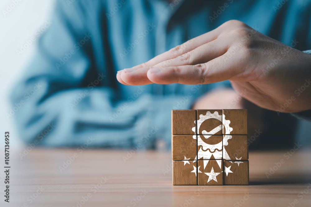 Poster Businessman hand protecting five stars quality icon which print screen on wooden block cube for quality control certificate and guarantee product and service