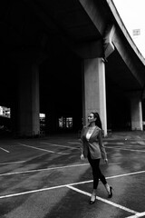 Black and white photo of a girl in classic clothes posing on the streets of Bangkok.
