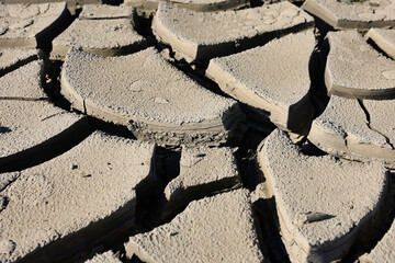 A riverbed dried up and cracked soil due to the lack of water and precipitation but also very high...