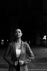 Black and white photo of a girl in classic clothes posing on the streets of Bangkok.