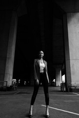 Black and white photo of a girl in classic clothes posing on the streets of Bangkok.