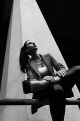 Black and white photo of a girl in classic clothes posing on the streets of Bangkok.