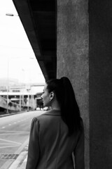 Black and white photo of a girl in classic clothes posing on the streets of Bangkok.