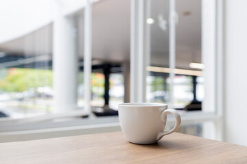 Minimalist White Coffee Cup on Wooden Table