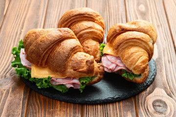 Croissant sandwich with salad ham and cheese . Top view