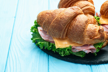 Croissant sandwich with salad ham and cheese . Top view