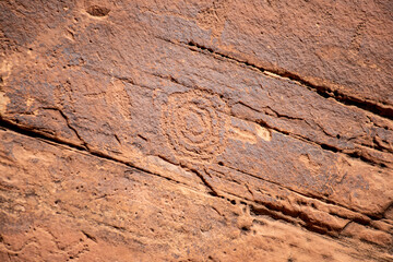 Detail of indigenous culture Petroglyphs etch in the walls along Potash Road in Moab Utah