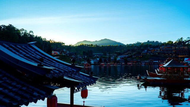 Time-lapse sunset ambient of "Ban Ruk Thai village" beside a beautiful lake with ancient chinese boat, a Village of Chinese settlement is a travel destination in Mae Hong Son province, unseen Thailand
