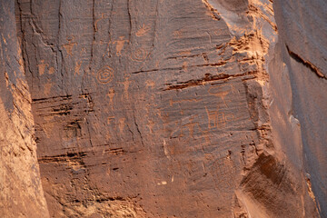 Detail of indigenous culture Petroglyphs etch in the walls along Potash Road in Moab Utah