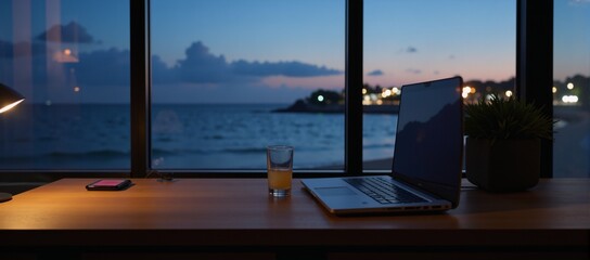 Fototapeta premium A nighttime vista from a resort hotel window showcases a late-summer scene with an ocean view a sleek cocktail and laptop adorn a nearby desk