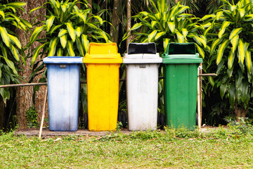 Old plastic trash garbage bin can, dustbin blue, yellow, white, green square shape. Waste...