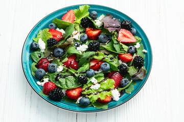 Berries salad (blueberry strawberry blackberry ) with cheese feta and balsamic sauce