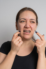 Young cheerful woman does hygiene for braces