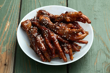 Caramelized korean or Chinese chicken foots ( paws ) with sesame . Top view