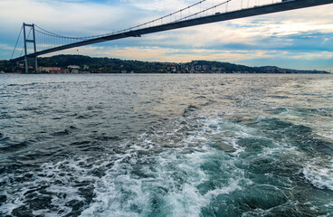 view from a pleasure boat on the Bosphorus and Bosphorus Bridge and cityscape of Istanbul, Turkey, the architecture of the city, a popular tourist destination.