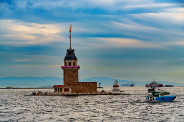 view from a pleasure boat on the Bosphorus and Kiz Kulesi Istanbul city Maiden's Tower, Turkey, the architecture of the city at sunset, a popular tourist destination.