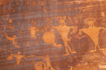 Detail of indigenous culture Petroglyphs etch in the walls along Potash Road in Moab Utah