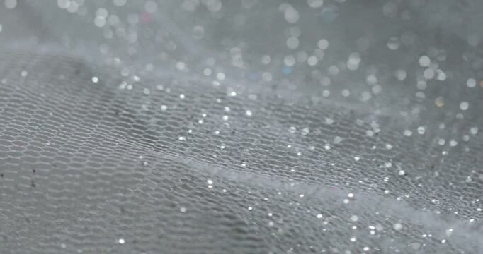 Gray tulle fabric with sparkling glitter.